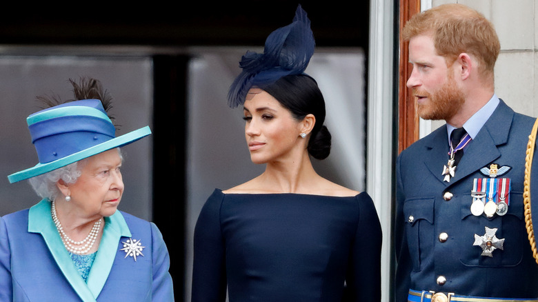 Queen Elizabeth angry, Meghan Markle eyes closed, Prince Harry talking