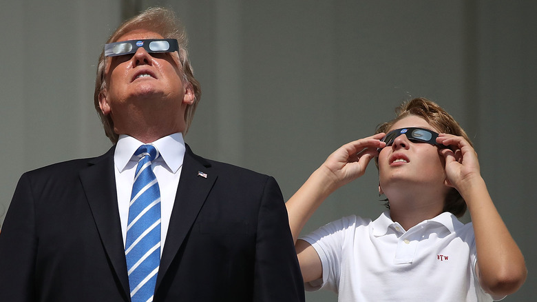 Donald Trump, Barron Trump wearing eclipse glasses