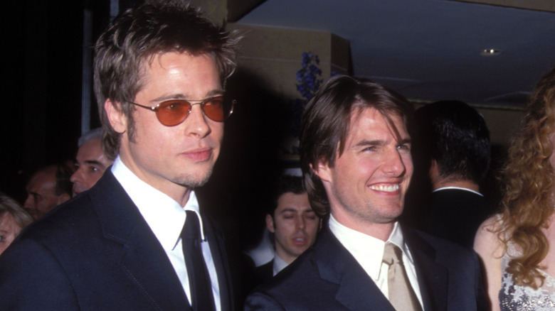 Brad Pitt wearing sunglasses, Tom Cruise smiling