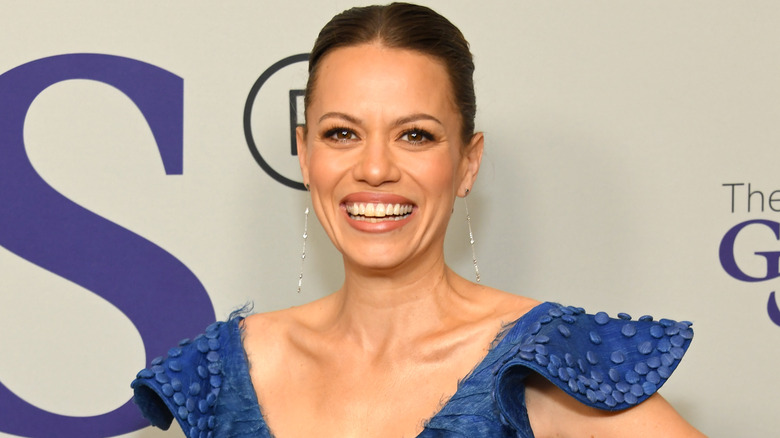 Bethany Joy Lenz smiling on red carpet in blue gown