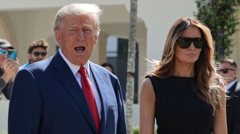 Donald Trump talks as Melania looks serious.