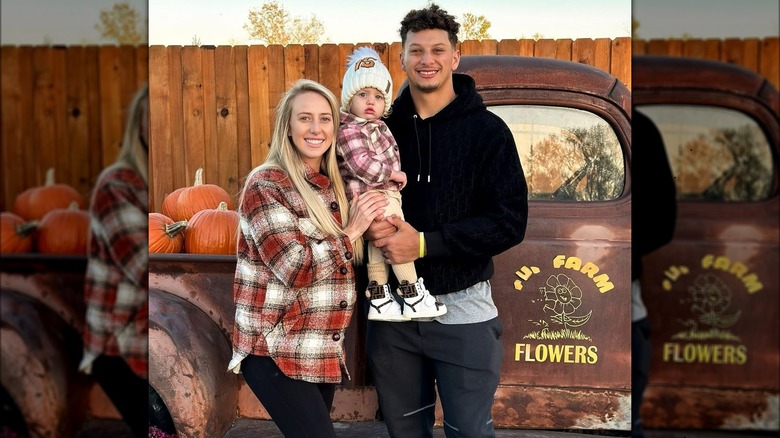 Mahomes family posing with old truck