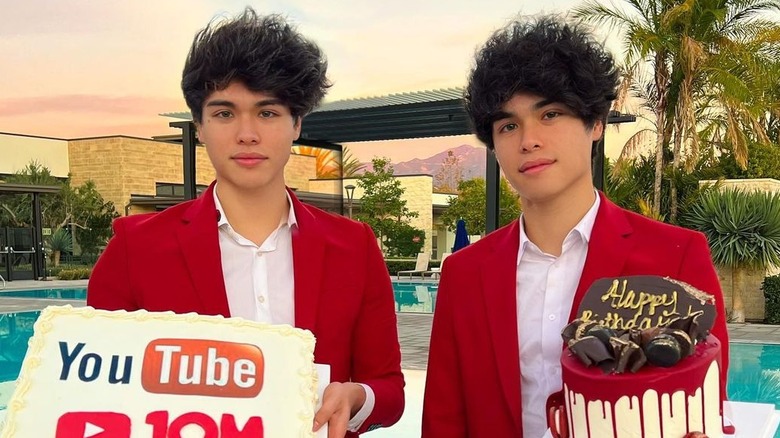 The Stokes twins posing with cakes