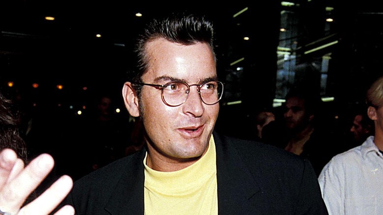 Charlie Sheen speaking, wearing glasses