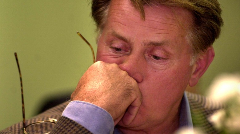 Martin Sheen resting hand on chin, looking down