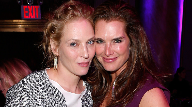 Uma Thurman cheek to cheek with Brooke Shields smiling