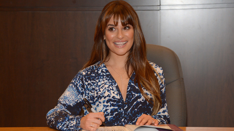 Lea Michele signing a book