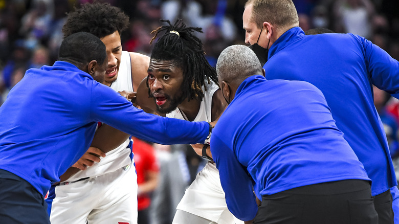 Isaiah Stewart held back by staff