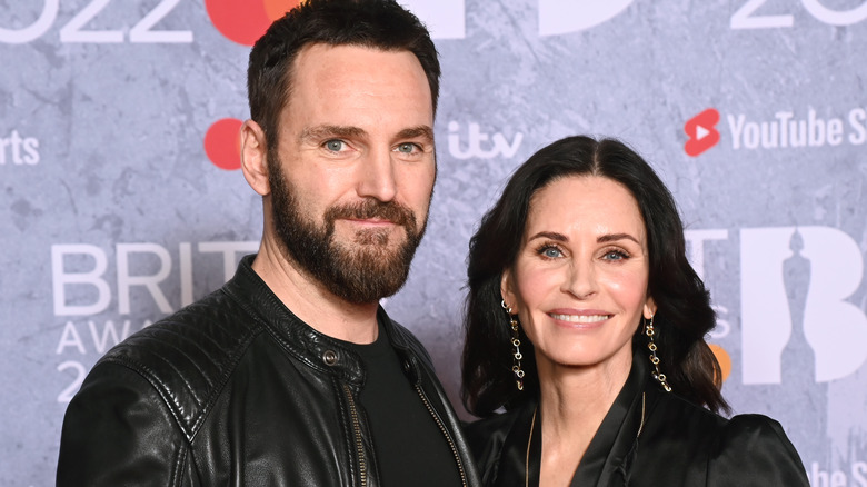 Johnny McDaid Courteney Cox smiling at 2022 Brit Awards