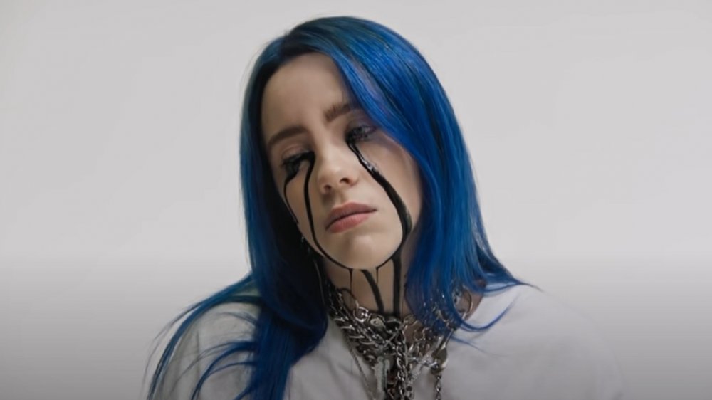 Billie Eilish with blue hair and black tears in her "When the Party's Over" music video