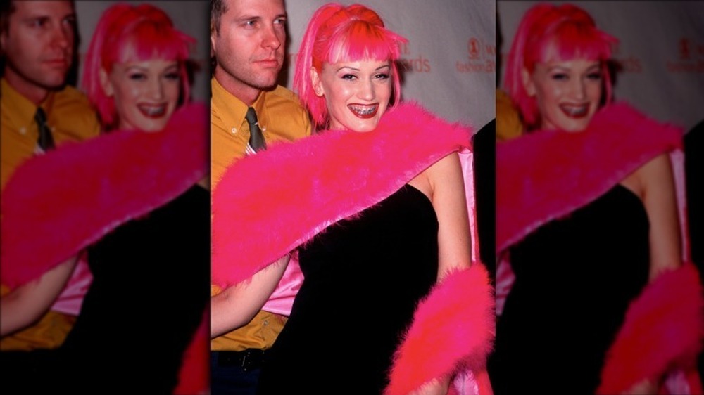 Gwen Stefani smiling with pink hair and braces