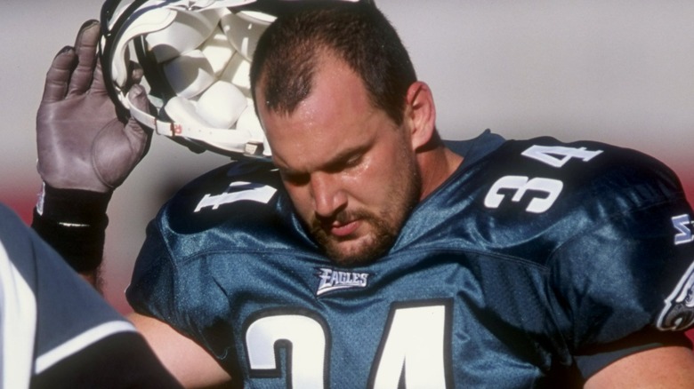 Kevin Turner removing football helmet