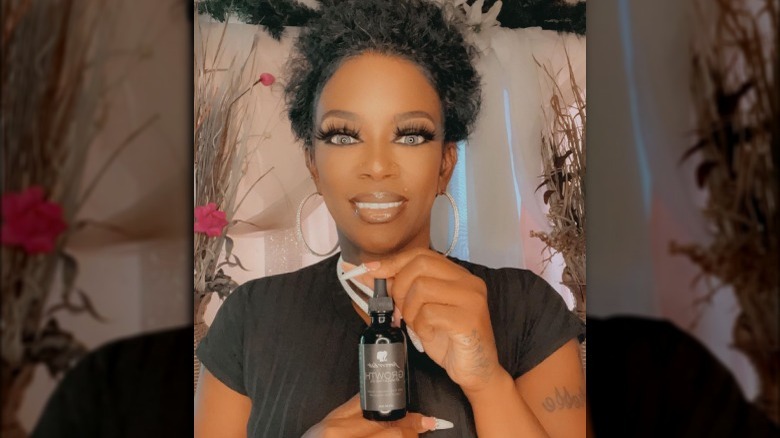 Tessica Brown showcasing her haircare products