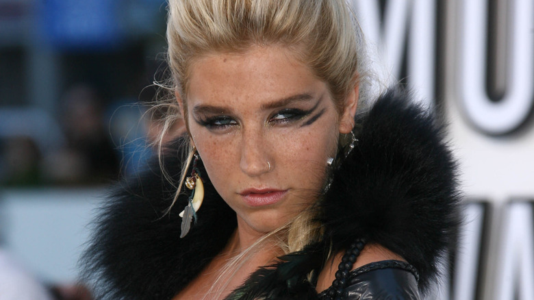 Kesha posing for cameras, wearing heavy eyeliner