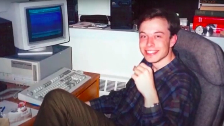 Elon Musk as a young man in front of a computer