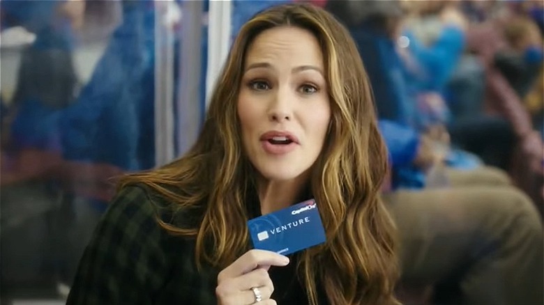 Jennifer Garner holding up a Capital One card