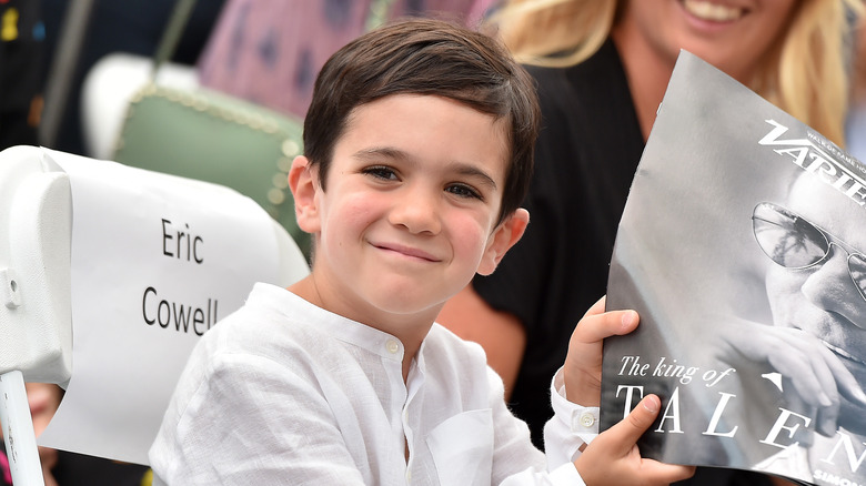 Eric Cowell smiling and holding Simon's magazine cover