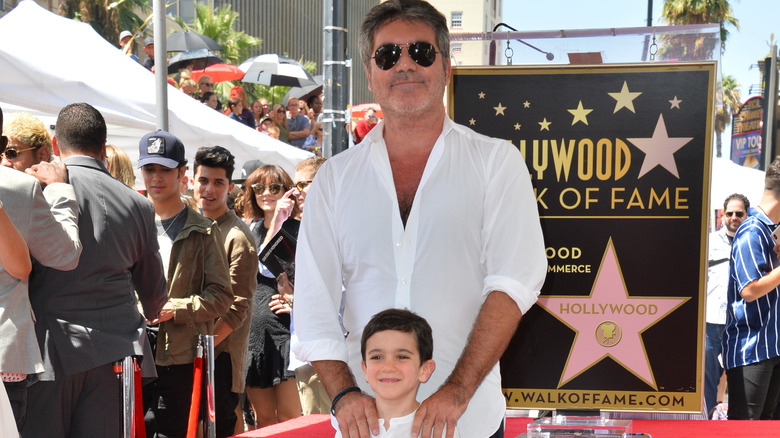 Eric Cowell and Simon Cowell posing together