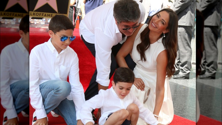 Simon Cowell, Eric Cowell, Adam Silverman, and Lauren Silverman posing at star on walk of fame