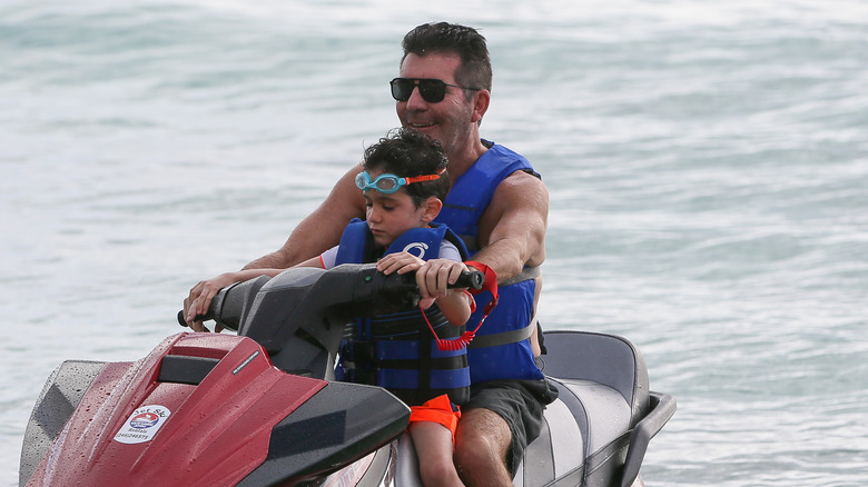 Eric and Simon Cowell riding jet ski 