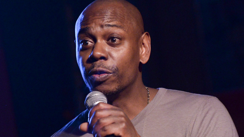 Dave Chappelle performs on stage