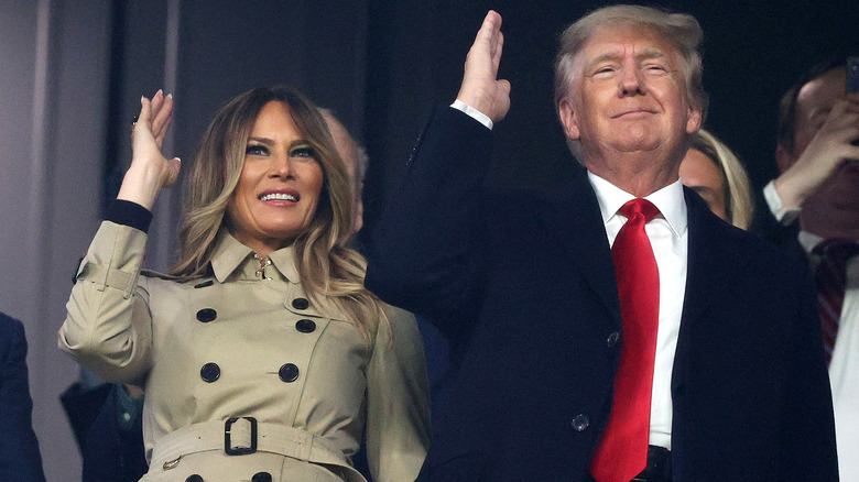 Donald and Melania Trump doing to tomahawk chop