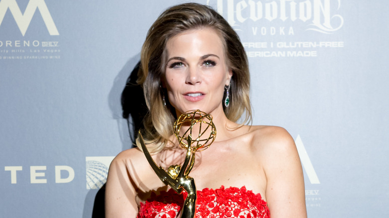 Gina Tognoni holding her Emmy