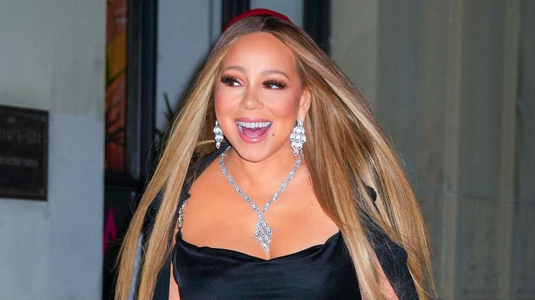 Mariah Carey smiling and walking