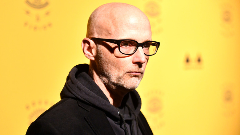 Moby posing in front of yellow background