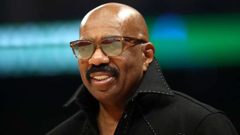 Steve Harvey wearing glasses, posing