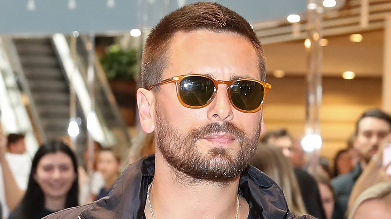 Scott Disick wearing sunglasses with serious expression