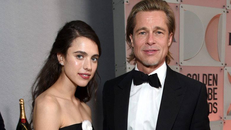 Margaret Qualley and Brad Pitt posing