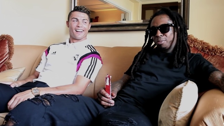 Cristiano Ronaldo sits next to Lil Wayne