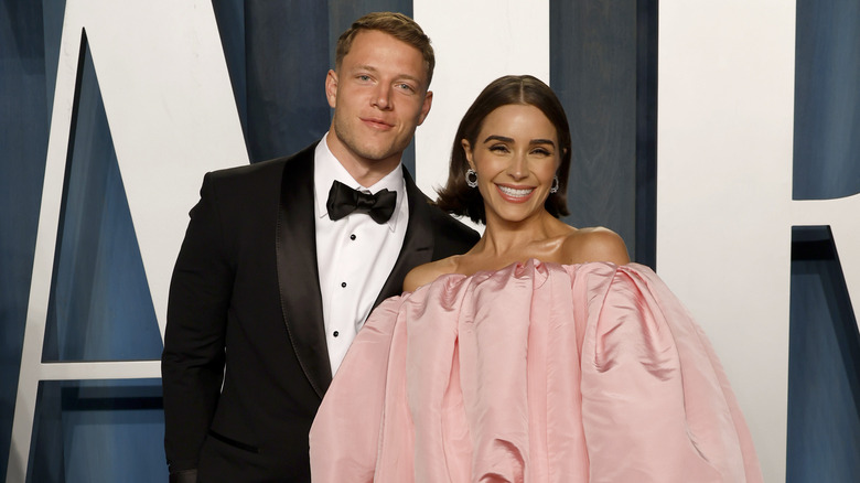 Christian McCaffrey posing with Olivia Culpo