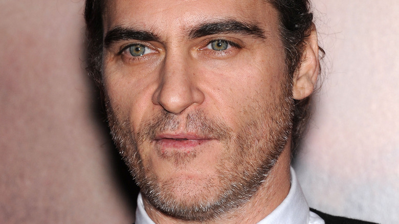 joaquin phoenix pouting with stubble 