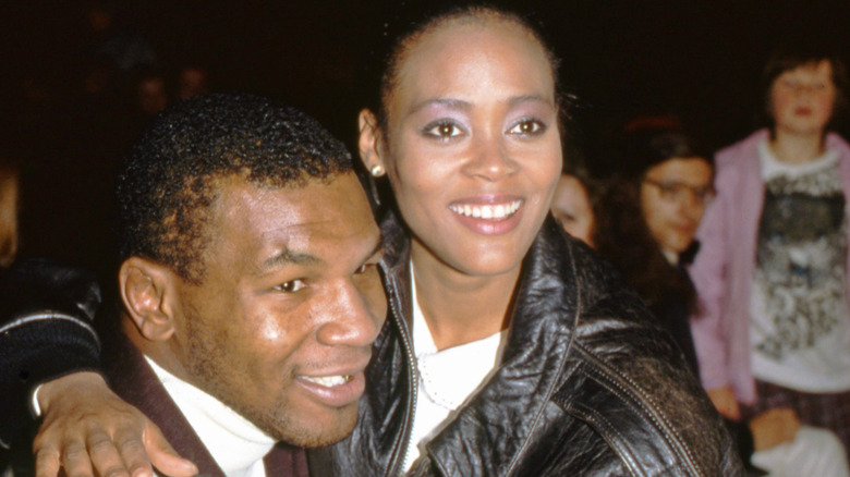 Mike Tyson being embraced by Robin Givens