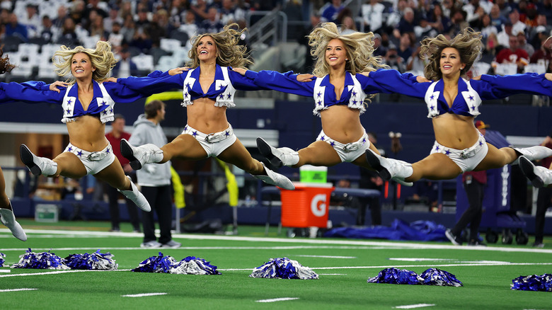 The Dallas Cowboys Cheerleaders performing a jump split.