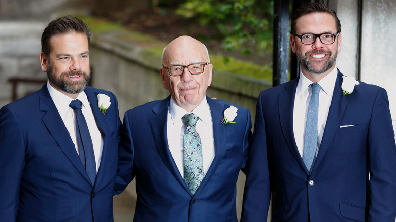 Rupert Murdoch posing with his sons, James and Lachlan