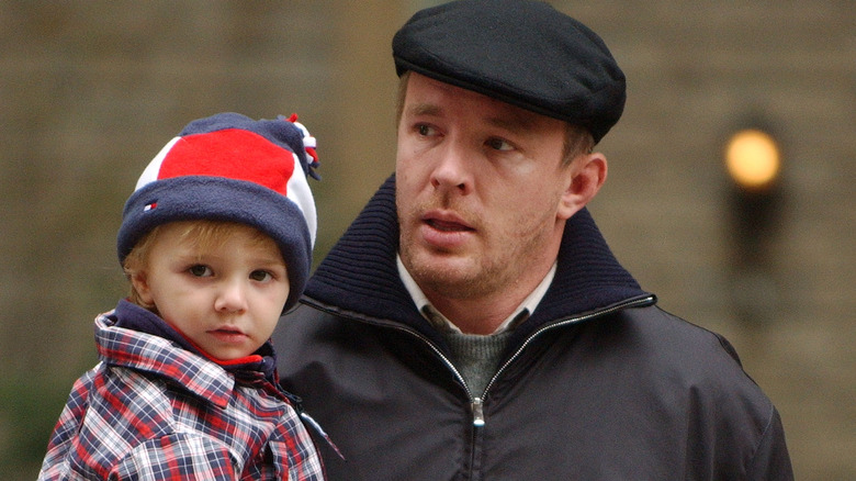 Rocco Ritchie posing with his dad, Guy Ritchie