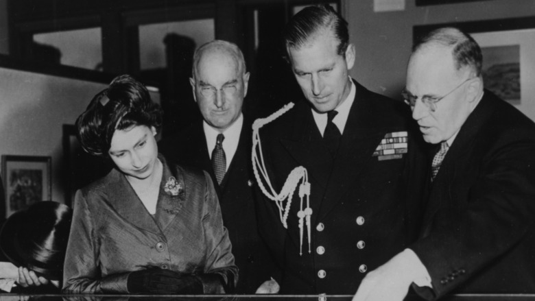 Queen Elizabeth and Prince Philip studying documents