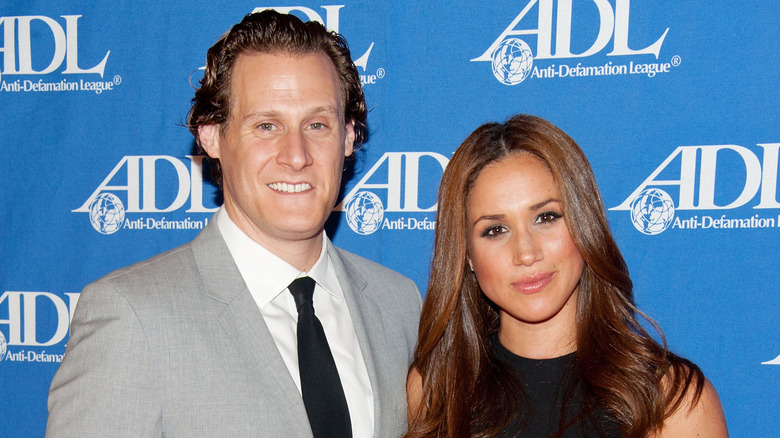 Trevor Engelson and Meghan Markle posing together