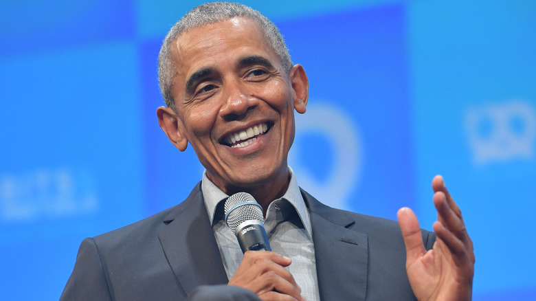 Barack Obama holding a microphone