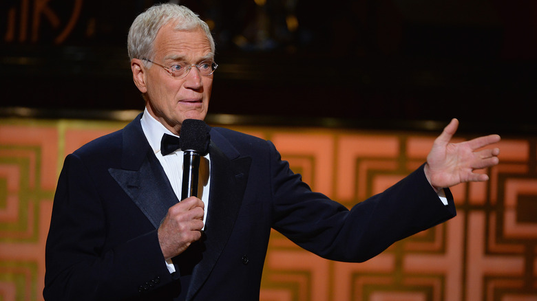 David Letterman addresses an audience on stage