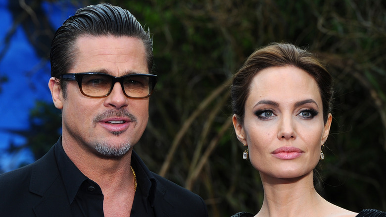 Brad Pitt glasses slicked back hair Angelina Jolie ponytail