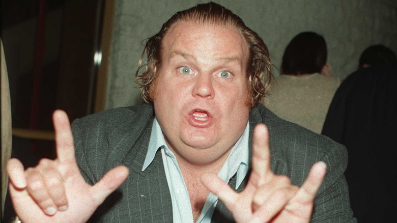 Chris Farley gestures to the camera