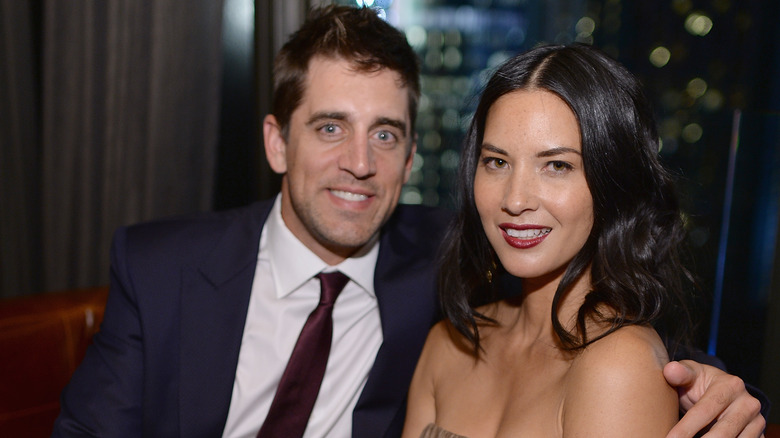 Aaron Rodgers smiling with Olivia Munn