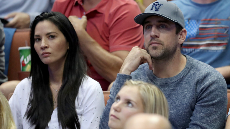 Olivia Munn sulking next to Aaron Rodgers