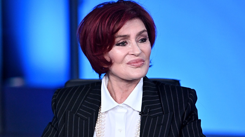 Sharon Osbourne seated, looking away