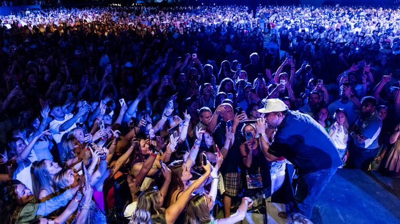 Luke Combs performing with audience 