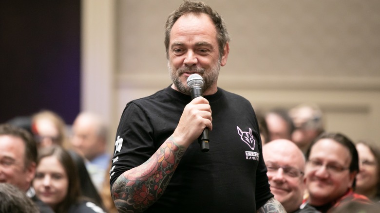 Mark Sheppard holding a mic